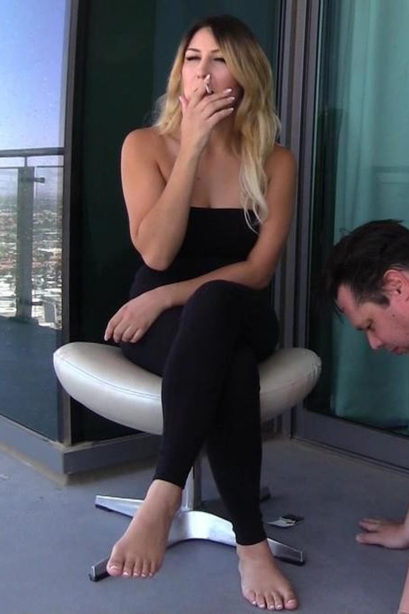 Skylar - Smokes Two Cigarettes on Balcony with Human Ashtray - Screenshot 1 of 4 - Domination
