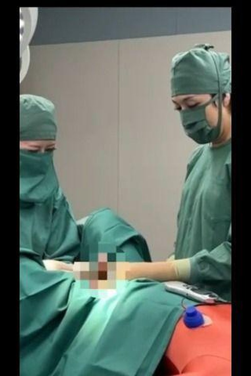 Patient Being Operated On By Two Doctors - Screenshot 1 of 4 - Asian